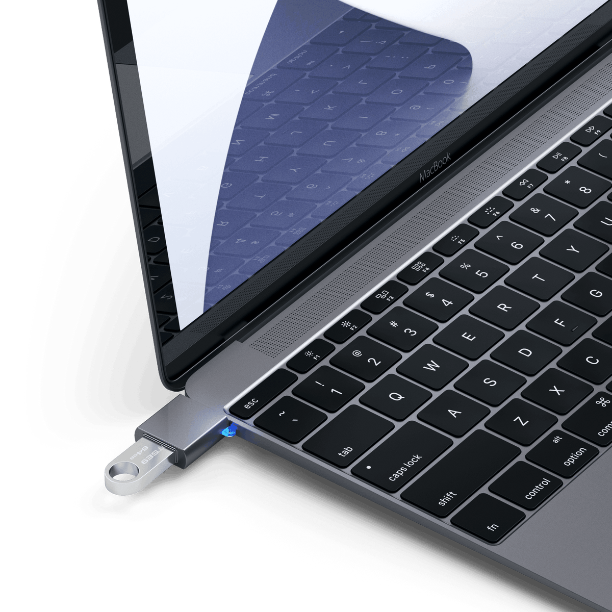 Aluminum USB-C to USB-A 3.0 Adapter in Space Gray plugged into a MacBook with a flash drive