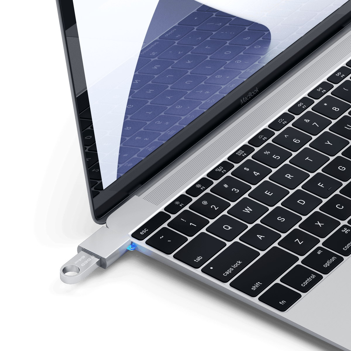 Aluminum USB-C to USB-A 3.0 Adapter in Silver plugged into a MacBook with a flash drive