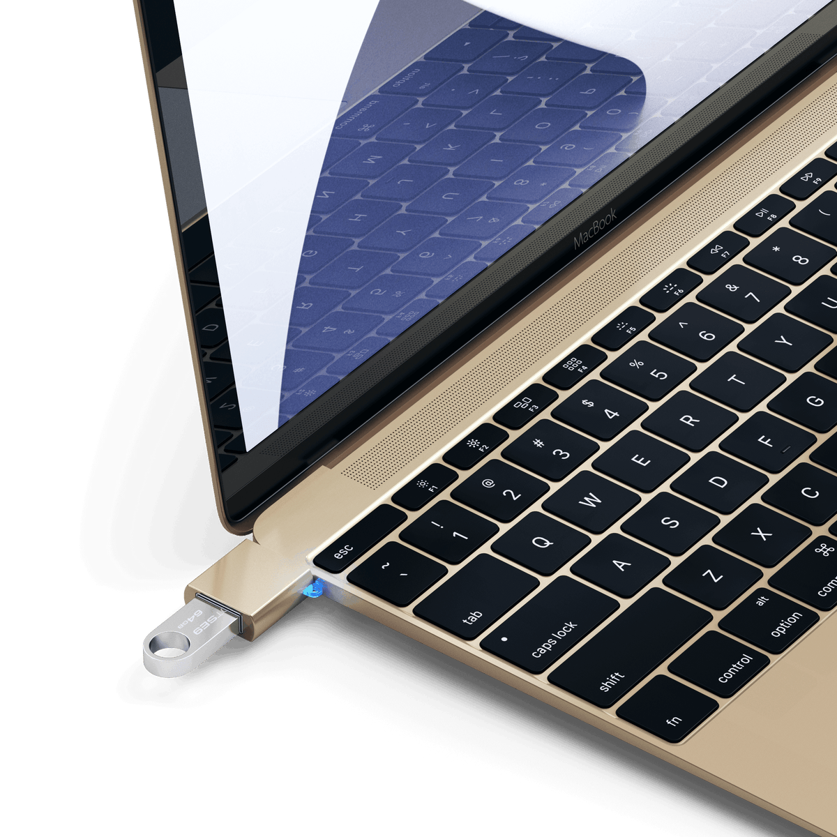 Aluminum USB-C to USB-A 3.0 Adapter in Gold plugged into a MacBook with a flash drive