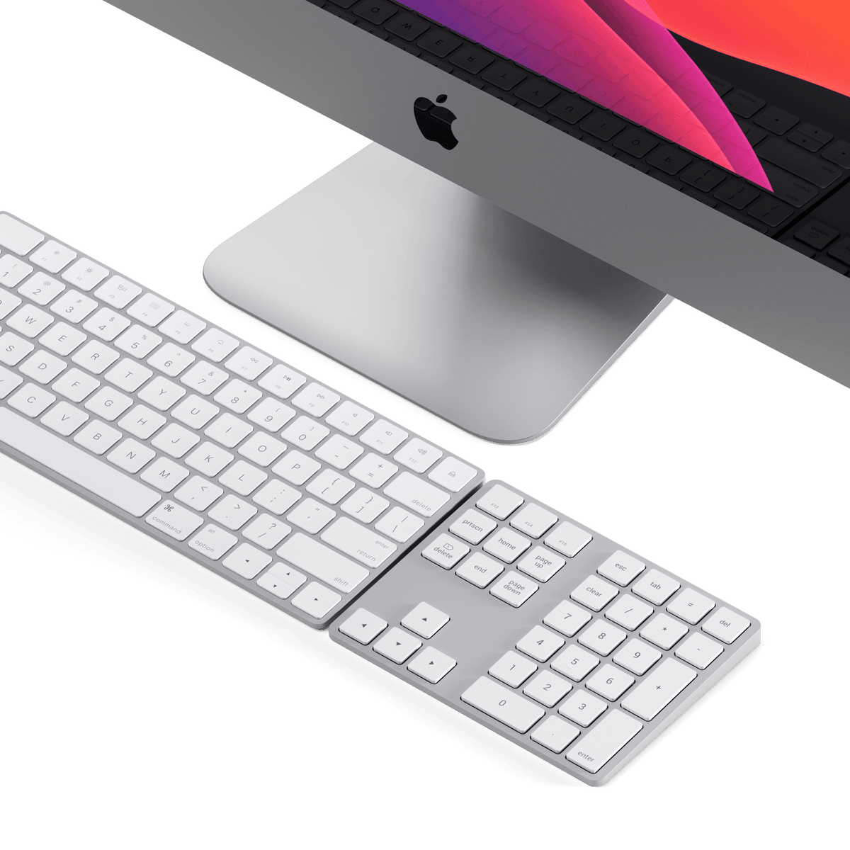 Bluetooth Extended Keypad in Silver next to a keyboard in front of an iMac