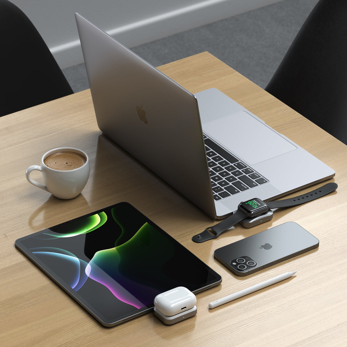 Dual Sided 2-in-1 USB-C Charger for Apple Watch and AirPods plugged into an iPad on a desk, charging AirPods, next to a MacBook, iPhone and Apple Watch