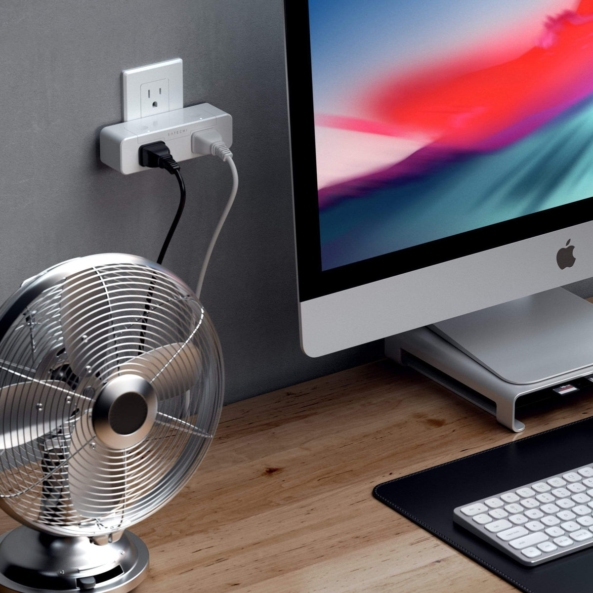 Dual Smart Outlet powering a desk fan next to an iMac