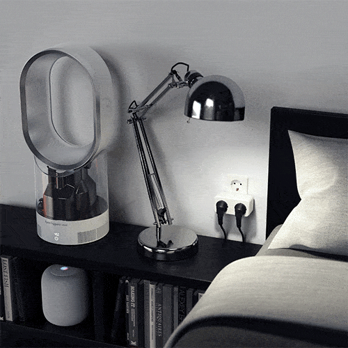 Dual Smart Outlet, EU version, powering a lamp and fan on a bedside table