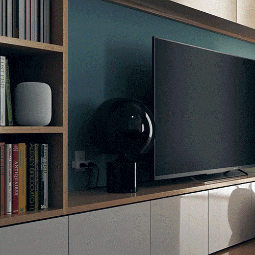 Dual Smart Outlet, EU version, plugged in behind a TV stand in a living room