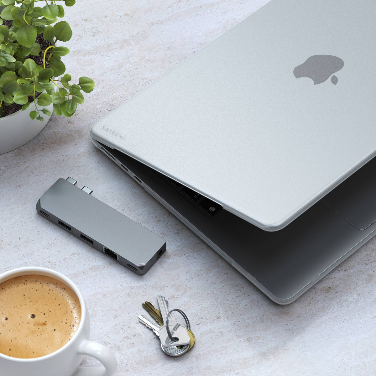 Eco-Hardshell Case for MacBook Air M2 in Clear on a MacBook Air next to a hub, keys and coffee