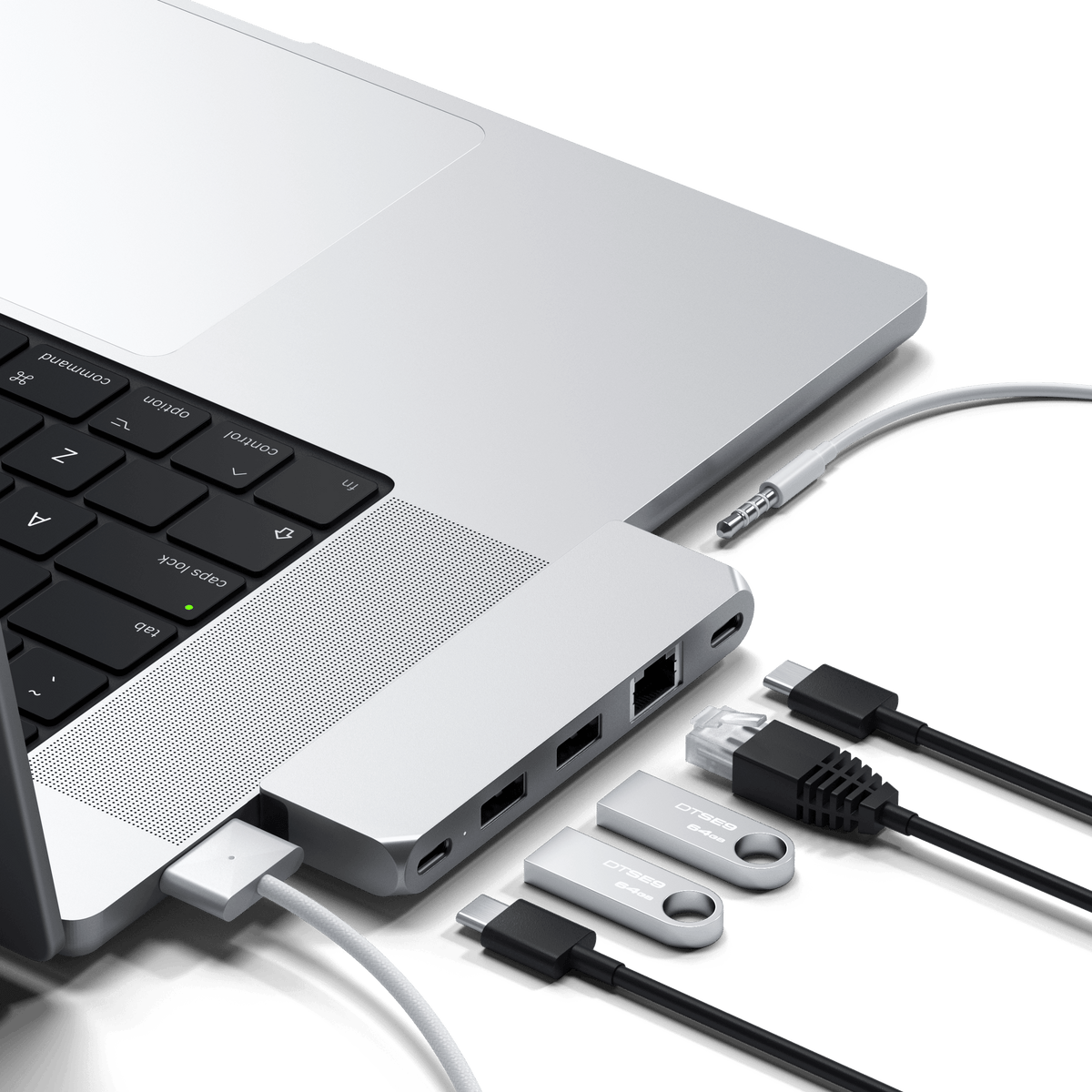 Pro Hub Mini in Silver plugged into the side of a MacBook Pro with cables connected