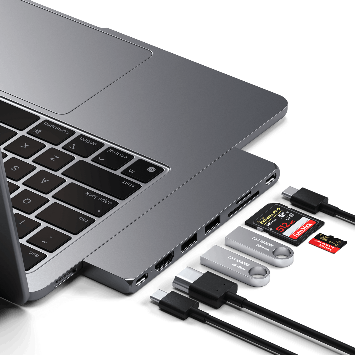 Pro Hub Slim in Space Gray plugged into the side of a MacBook with cables and SD cards connected