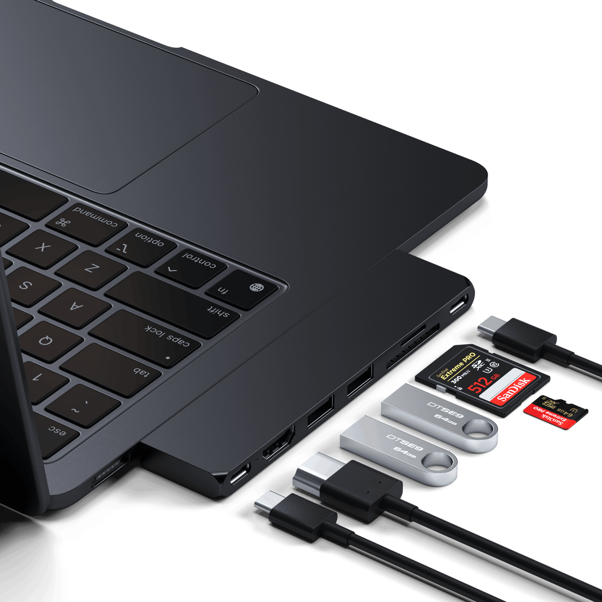 Pro Hub Slim in Midnight plugged into the side of a MacBook with cables and SD cards connected