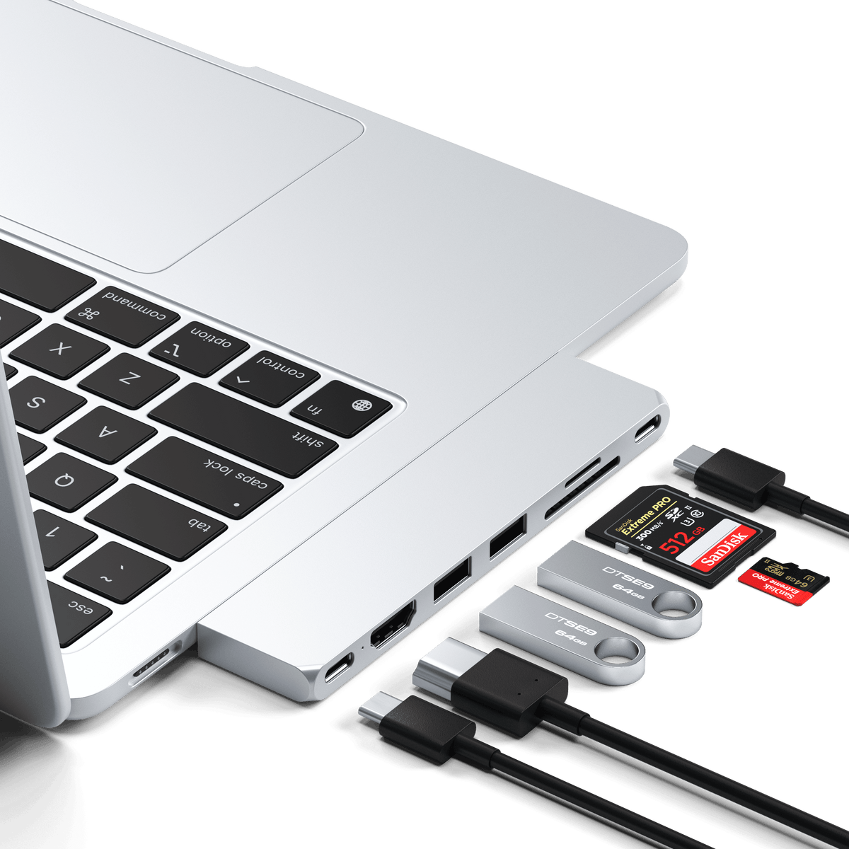 Pro Hub Slim in Silver plugged into the side of a MacBook with cables and SD cards connected