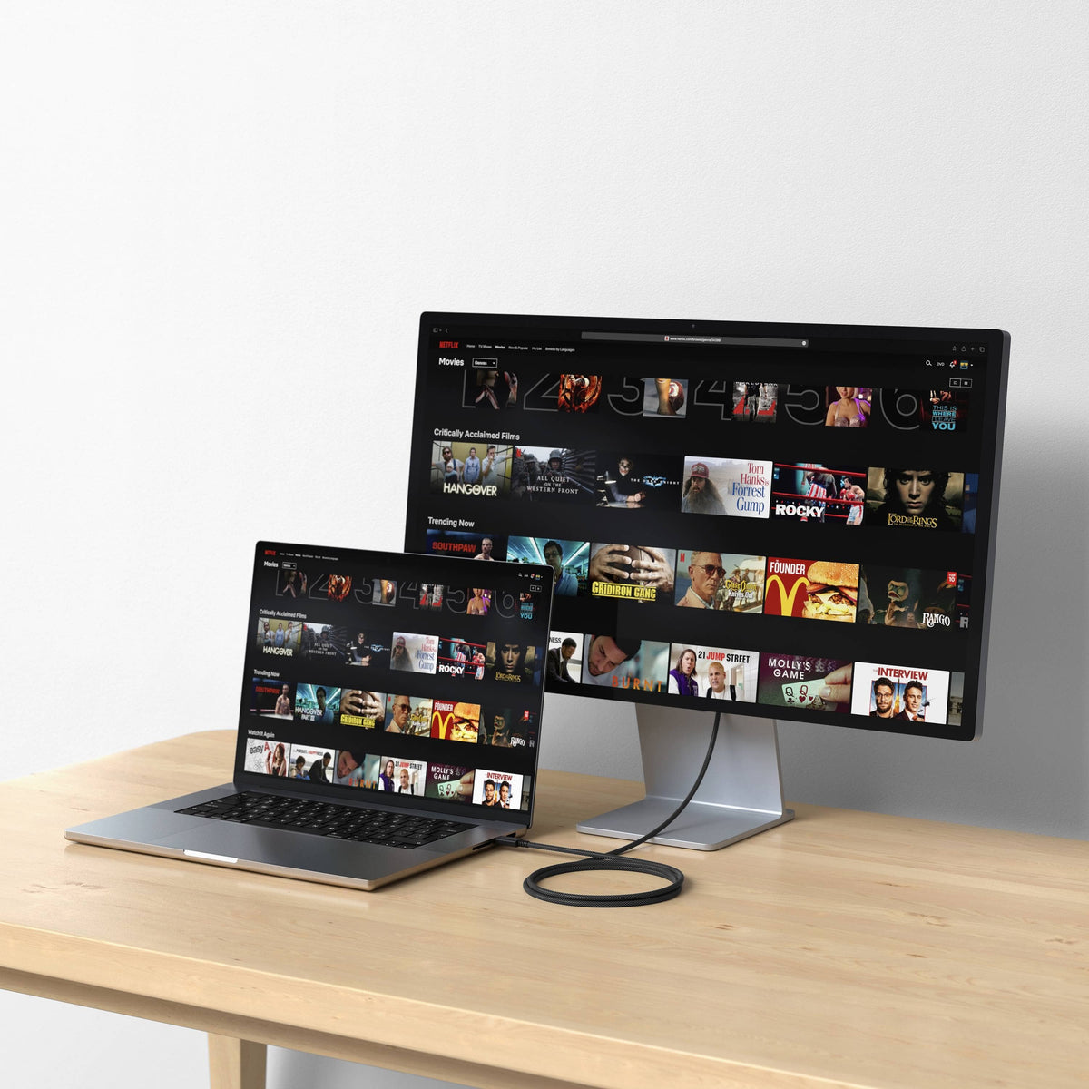 Satechi Thunderbolt 4 Pro Cable connecting a MacBook Pro to an external monitor on a wooden desk