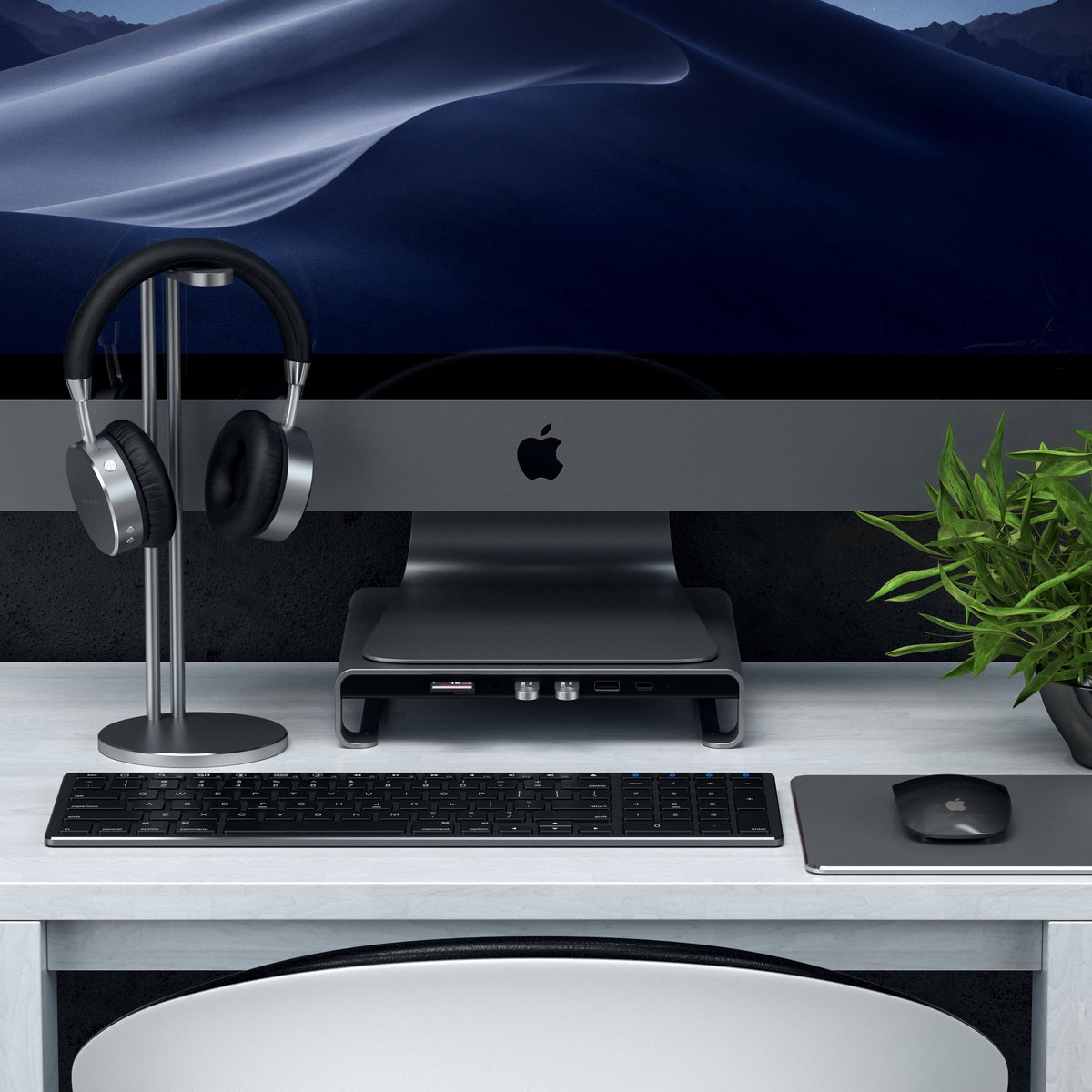 Type-C Aluminum Monitor Stand Hub for iMac in Space Gray under an iMac with a headphone stand and keyboard