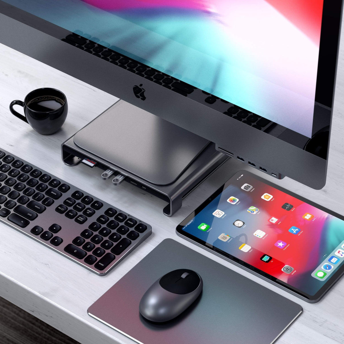 Type-C Aluminum Monitor Stand Hub for iMac in Space Gray under an iMac, top-down view with keyboard, mouse and iPad