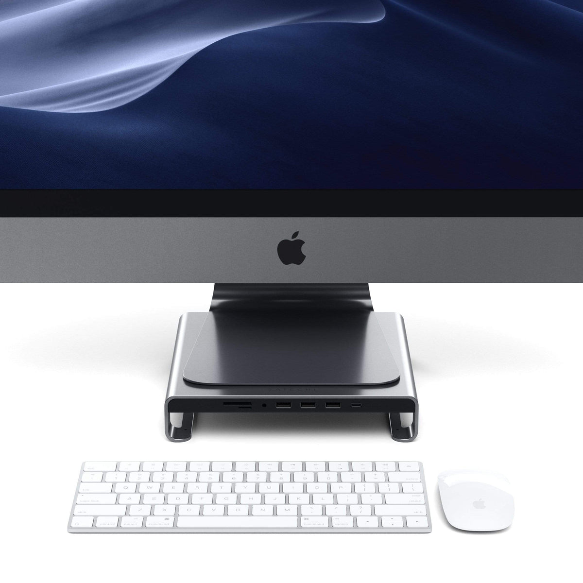 Type-C Aluminum Monitor Stand Hub for iMac in Space Gray under an iMac with keyboard and mouse, front view