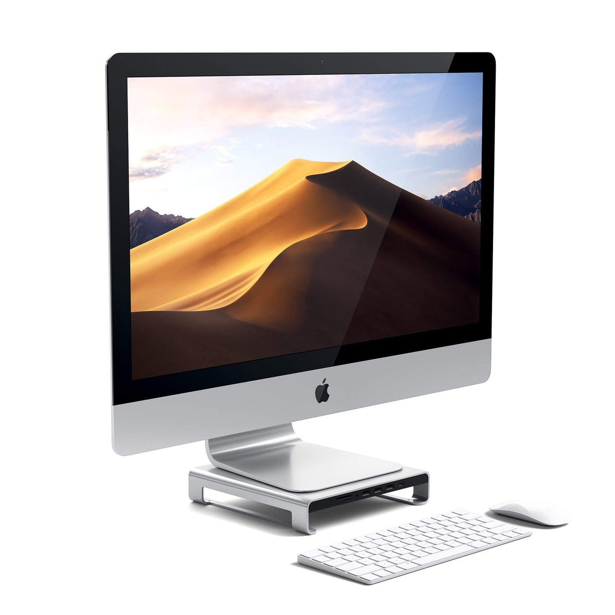 Type-C Aluminum Monitor Stand Hub for iMac in Silver under an iMac with keyboard and mouse, angled view