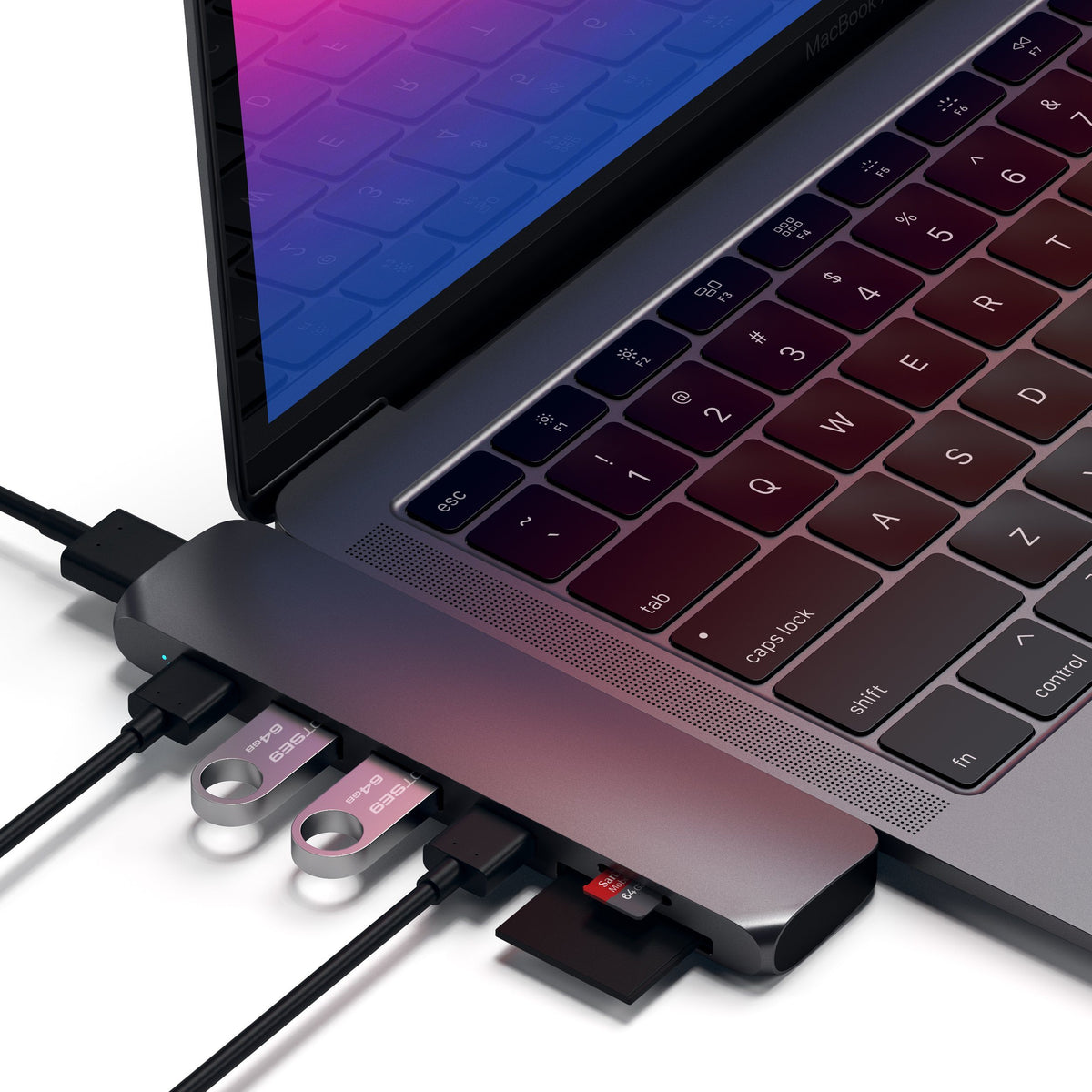 Type-C Pro Hub Adapter in Space Gray plugged into a MacBook Pro with cables, flash drives and an SD card