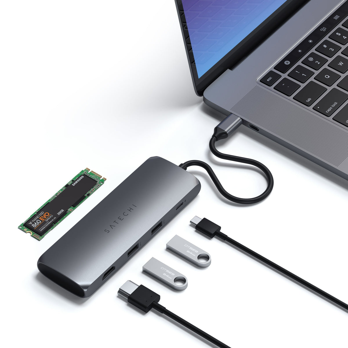 USB-C Hybrid Multiport Adapter in Space Gray connected to a laptop with an M.2 SSD, HDMI cable and flash drives