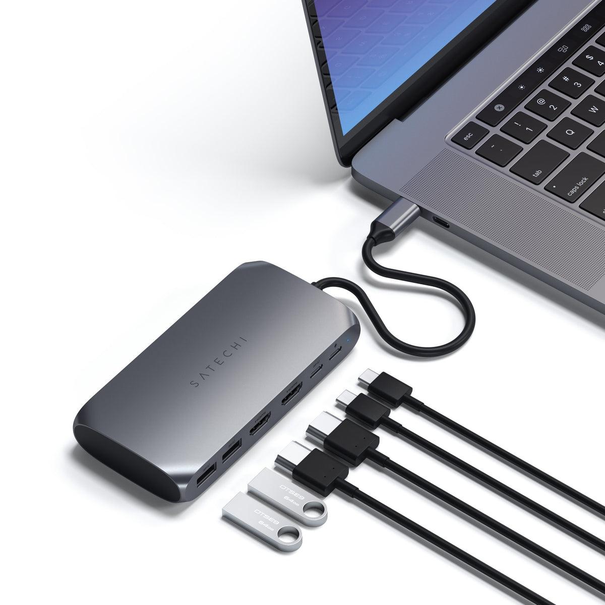 USB-C Multimedia Adapter M1 connected to a laptop with HDMI, USB cables and flash drives