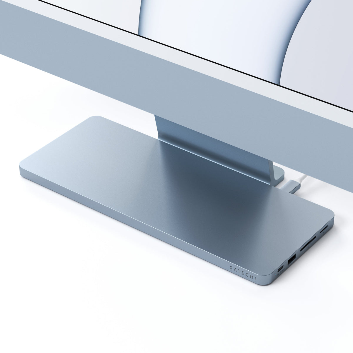 USB-C Slim Dock for 24" iMac in Blue under an iMac stand, close up of front ports