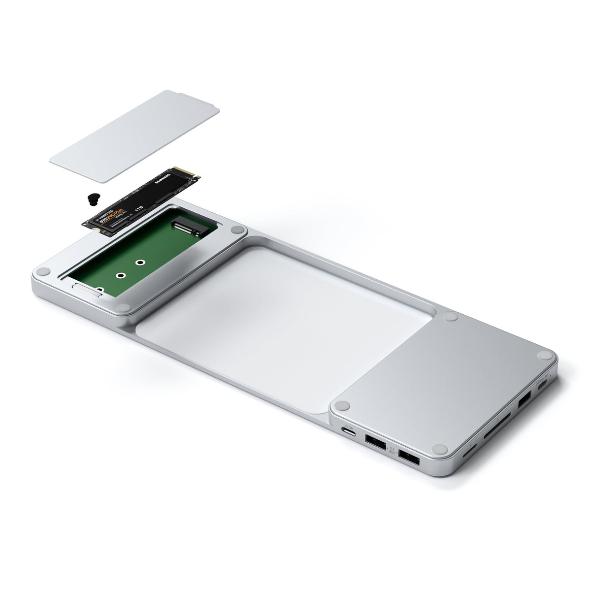 USB-C Slim Dock for 24" iMac in Silver with the SSD compartment open and an M.2 SSD being installed