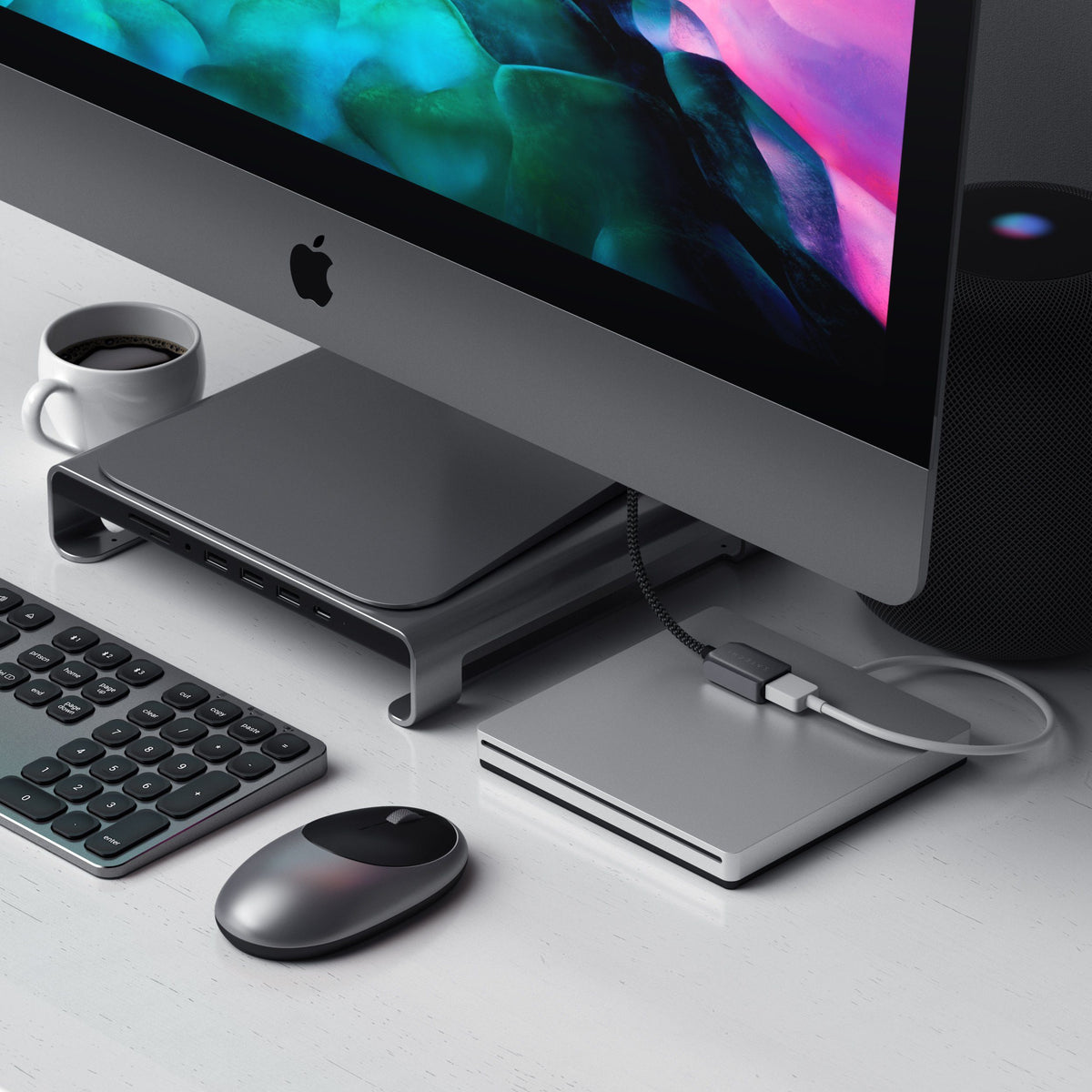 USB-C to USB 3.0 Adapter Cable connecting an external drive to an iMac on a stand hub, next to a keyboard and mouse