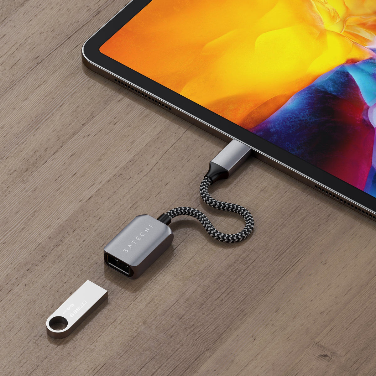 USB-C to USB 3.0 Adapter Cable connecting a USB flash drive to an iPad Pro on a wooden table